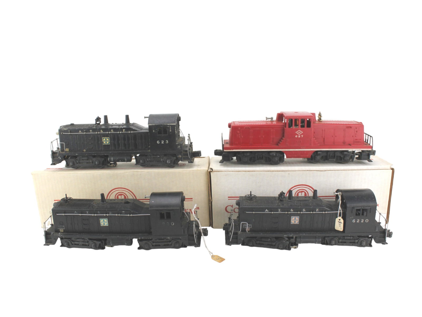 Four Lionel O Gauge Locomotives: Two A. T. & S. F. 6220 model, one A. T. & S. F. 623 model and one LV 627. The locomotive is Approx. 11 in. (L)