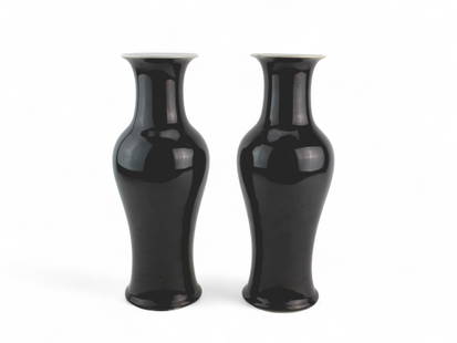 Pair of Chinese Black-Glazed Porcelain Vases: A matched pair of Chinese porcelain vases featuring a glossy black glaze over a baluster form body, flaring into wide white-glazed mouths. Each base is inscribed with a six-character mark, written in