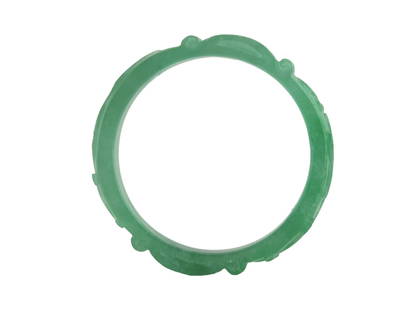 Carved Green Jadeite Bangle Bracelet: Finely carved green jadeite bangle featuring decorative motifs and traditional Chinese symbols around the outer edge. The bangle displays a translucent green hue with slight natural mottling. In very