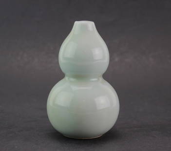 Chinese Celadon Double Gourd Vase: A small porcelain vase with a smooth pale green celadon glaze, shaped in a traditional double-gourd form. Unmarked base with a glossy finish and elegant curves. It measures approximately 4 inches in h