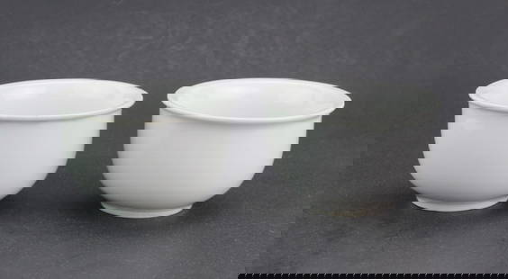 Two Chinese Blanc de Chine Porcelain Tea Cups: A pair of plain white glazed porcelain teacups with flared rims and smooth bodies. One has a small rim chip. Each cup measures approximately 3 1/4 in. (D) X 2 in. (H).