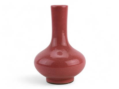 Chinese Langyao Red Crackle-Glazed Bottle Vase: A Chinese porcelain vase with a Langyao red glaze and crackle finish, featuring a rounded body and tall neck. It bears an apocryphal Ming mark on the base. 20th century. It measures approximately 6 in