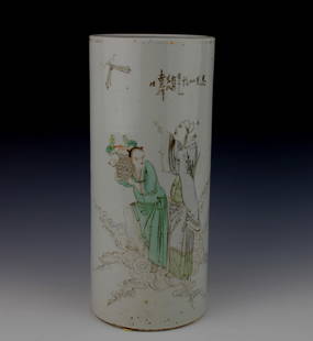 CHINESE FAMILLE ROSE CYLINDRICAL VASE: A cylindrical Chinese porcelain vase decorated in famille rose enamels, depicting two immortal-style figures among clouds—one holding a peach basket. The scene is accompanied by an inscription in Ch