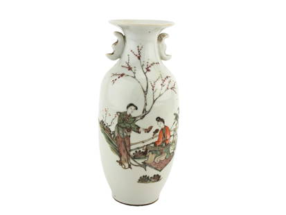 CHINESE QIANJIANG POLYCHROME FIGURE VASE: A slender porcelain vase painted in famille rose enamels, depicting two women in a garden beneath blossoming branches. The reverse bears a Chinese poetic inscription in black script. The vase features
