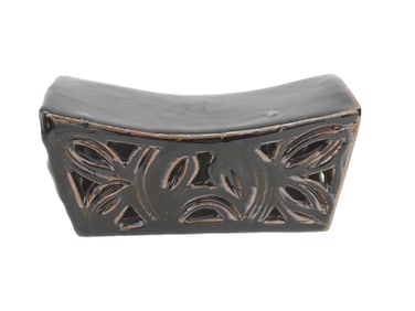 A Chinese Black Glazed Carved Ceramic Headrest