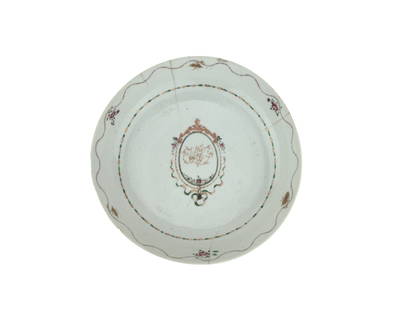 Chinese Export Armorial Saucer with Monogram: A Chinese export porcelain plate decorated in famille rose palette, featuring a central oval medallion enclosing a delicate floral crest and monogram. The border is adorned with scattered floral spray