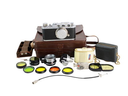 Leica II Ernst Leitz Wetzlar Camera & Accessories: Circa 1937, serial#222996, Leica II with 50mm lense, leather outfitted case with key, view finder, D.R.P. Autoknips timer, Sixtomat light meter, close-up attachment, and various filters. Stamped "Germ