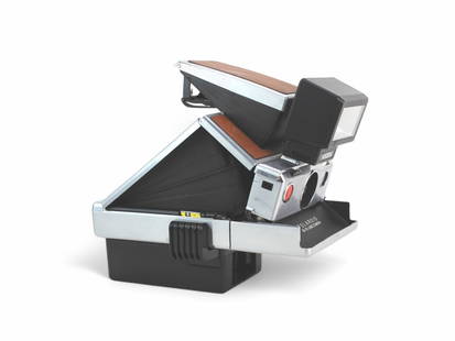 Polaroid SX-70 Land Camera: Polaroid SX-70 instant film, compact, folding SLR Land Camera. Circa 1972. With a Nissan FSX flash.