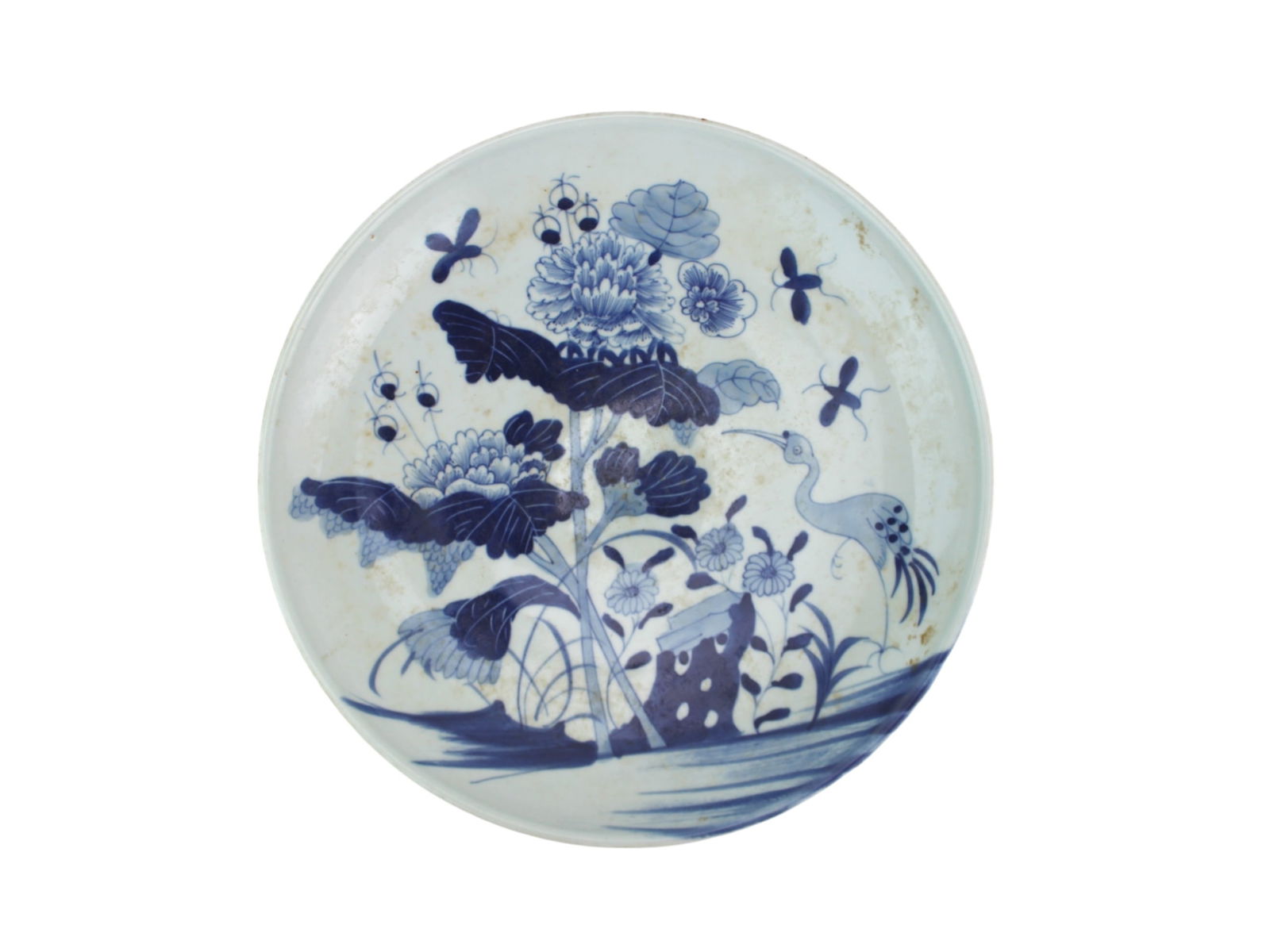 Chinese B/W Porcelain Platter With Crane and Lotus: Chinese Blue and White Porcelain Plate with Crane — Decorated in underglaze blue with a crane among lotus blossoms and butterflies. Shows age-related discoloration, surface wear, and minor glaze fri