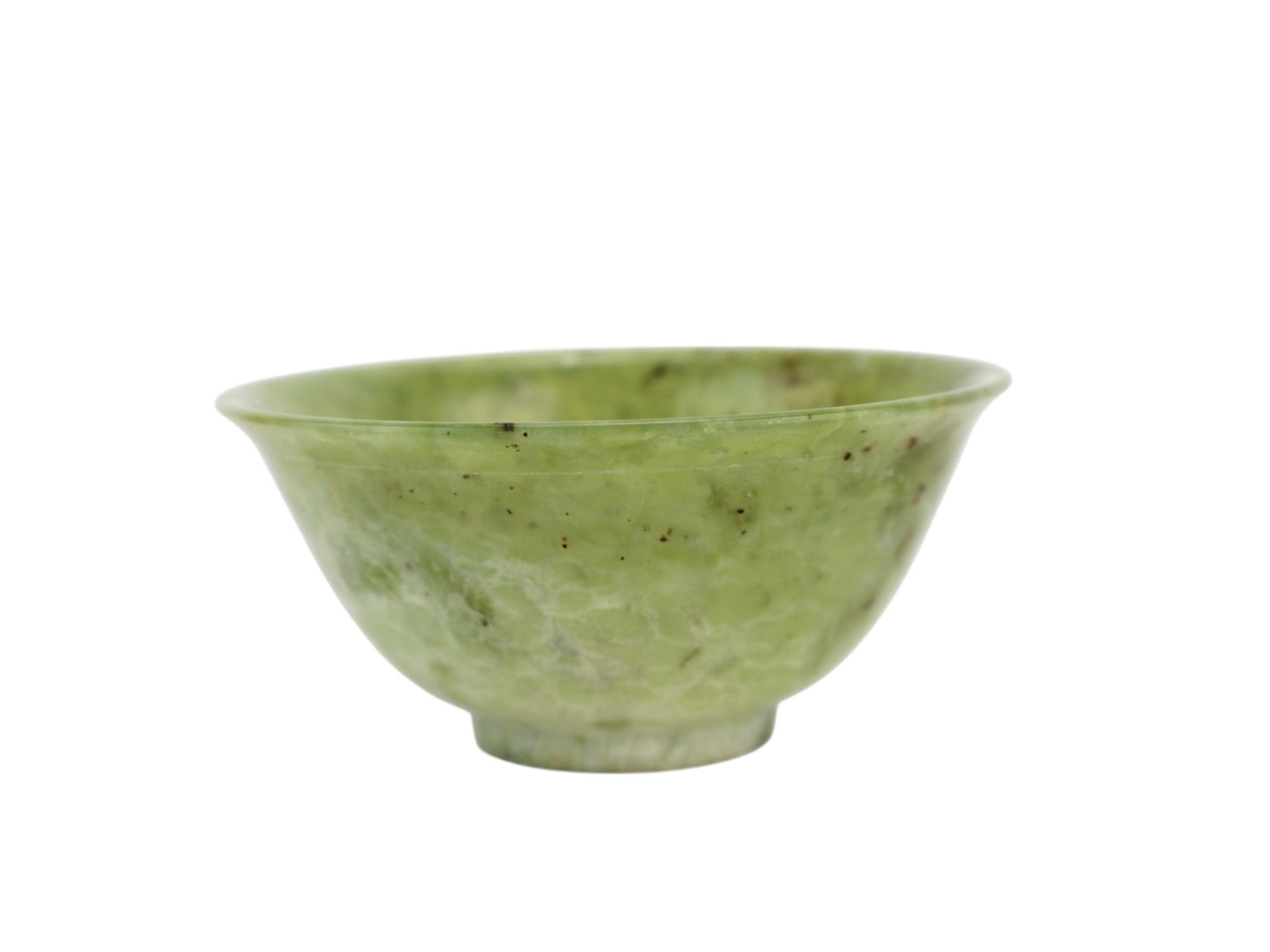 A Chinese Hardstone Bowl: A Chinese green hardstone bowl featuring a flared rim and rounded sides, resting on a short foot. The bowl is carved from semi-translucent green stone with natural dark speckling. Dimensions: 4 in. Di