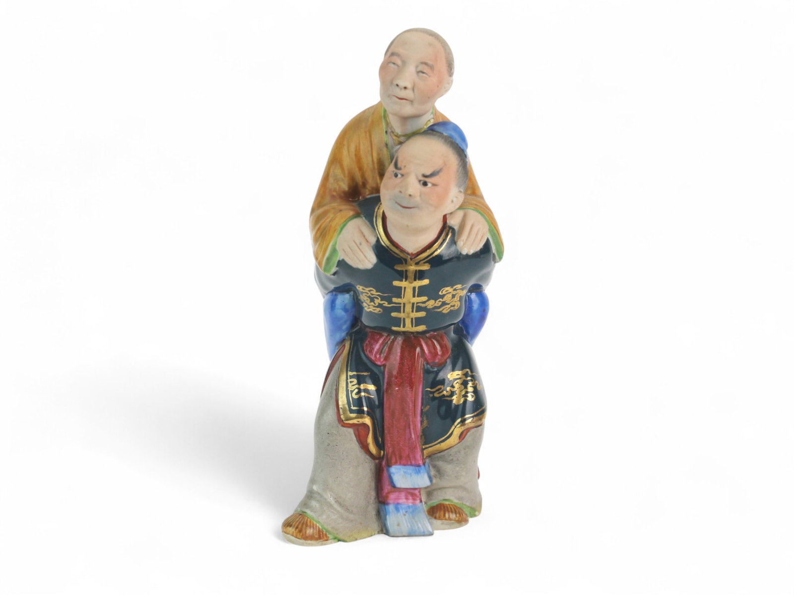 Chinese Porcelain Figurine of Man Carrying Elder: Finely modeled Chinese porcelain figurine of a man carrying an elderly figure, both in brightly enameled robes with gilt accents. Skillfully detailed faces and posture. Approx. 8 in. high. Good condit