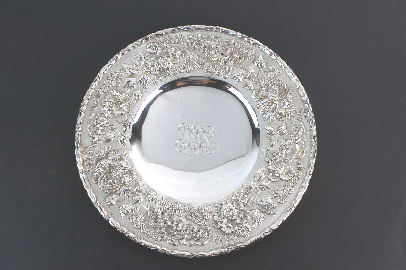 S. Kirk & Son Sterling Floral Plate: Sterling silver plate by S. Kirk & Son Co., featuring an ornate repoussé floral and foliate border. Marked “S. Kirk & Son Co. 925/1000 193” on reverse. Measures approx. 11 in. in diameter, we