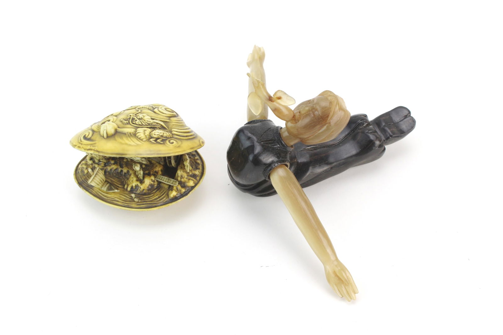 Resin Shell & Horn Carving Figures: Pair of decorative carvings—a resin shell with dragon and village motifs, and a horn carving of a reclining figure with damaged bird. Finely detailed with minor age wear. Sizes: 4¾ X 6¾