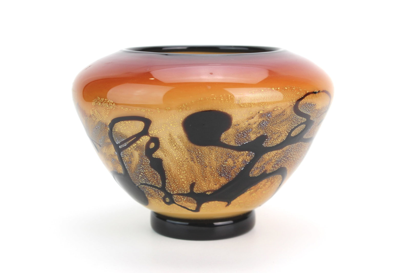 Signed Norwest Studio Art Glass Bowl: Contemporary studio art glass bowl signed “Norwest 56.17.01 JW” on base, featuring a rich amber-to-red gradient with black abstract overlays and gold flecks. Approx. 6 1/4 × 4 1/2 in. Excelle