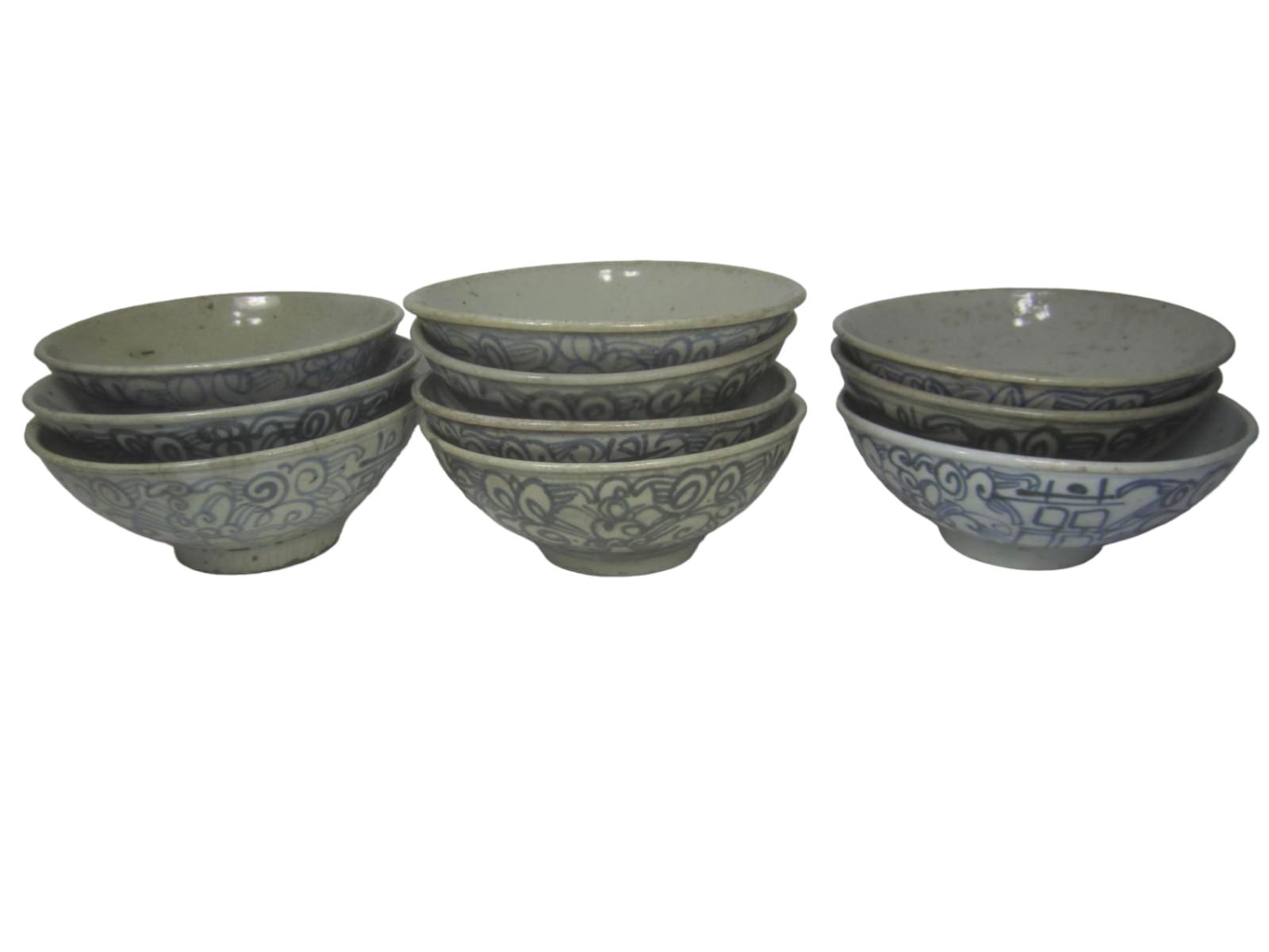 Group of Ten Chinese Blue and White Bowls: Set of ten Chinese blue and white bowls with scroll designs, varying glaze tones, and minor rim chips and wear. Largest 6 in. (D) x 2 1/4 in. (H).