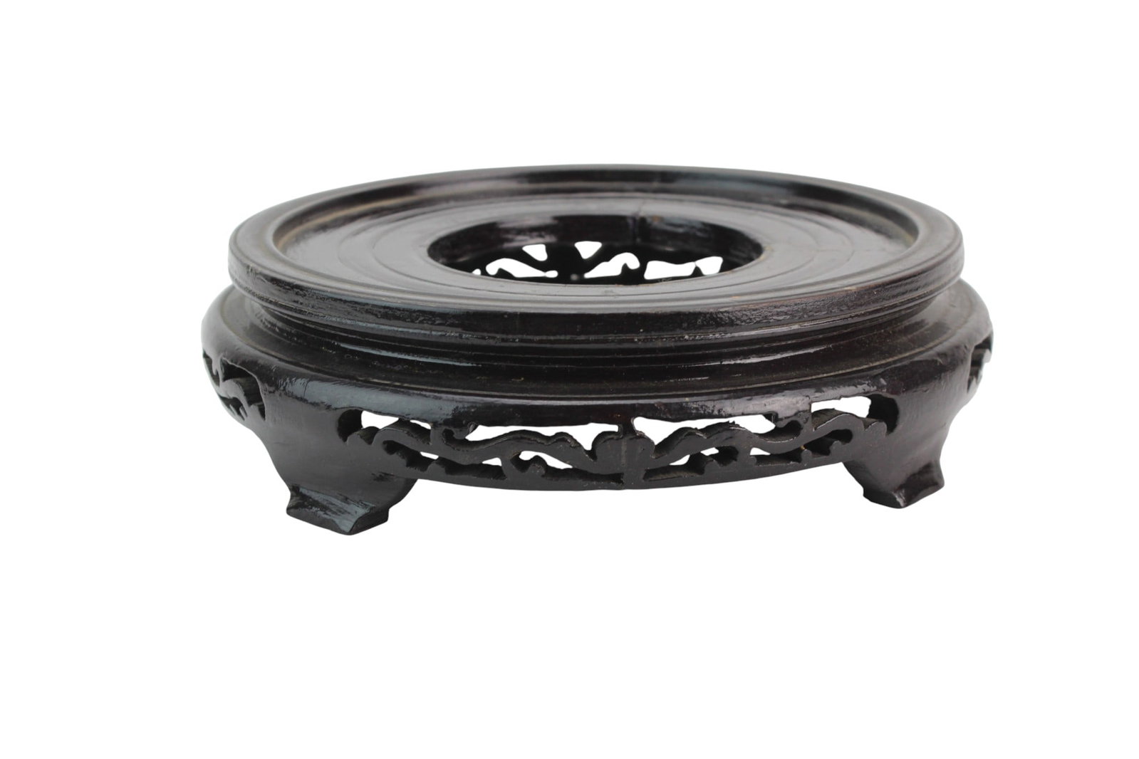 Black Carved Wood Stand with Openwork Legs: Black wood stand with openwork carvings and short feet, showing light wear and surface scratches. Size: 2 1/4 in. (H) X 8 3/4 in. (D).