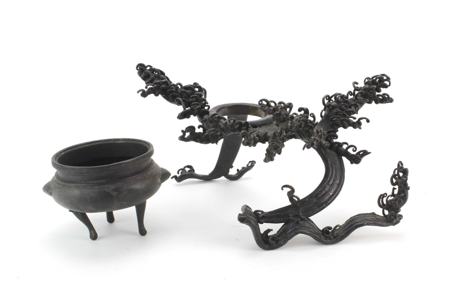 Chinese Bronze Dragon Stand & Tripod Censer: Group of two Chinese bronze pieces, including a dragon-form sculpture stand and a tripod censer. The sculpture stand measures approx. 9 1/2 X 9 1/2 X 5 3/4 in., and the censer measures approx. 4 1/4 X