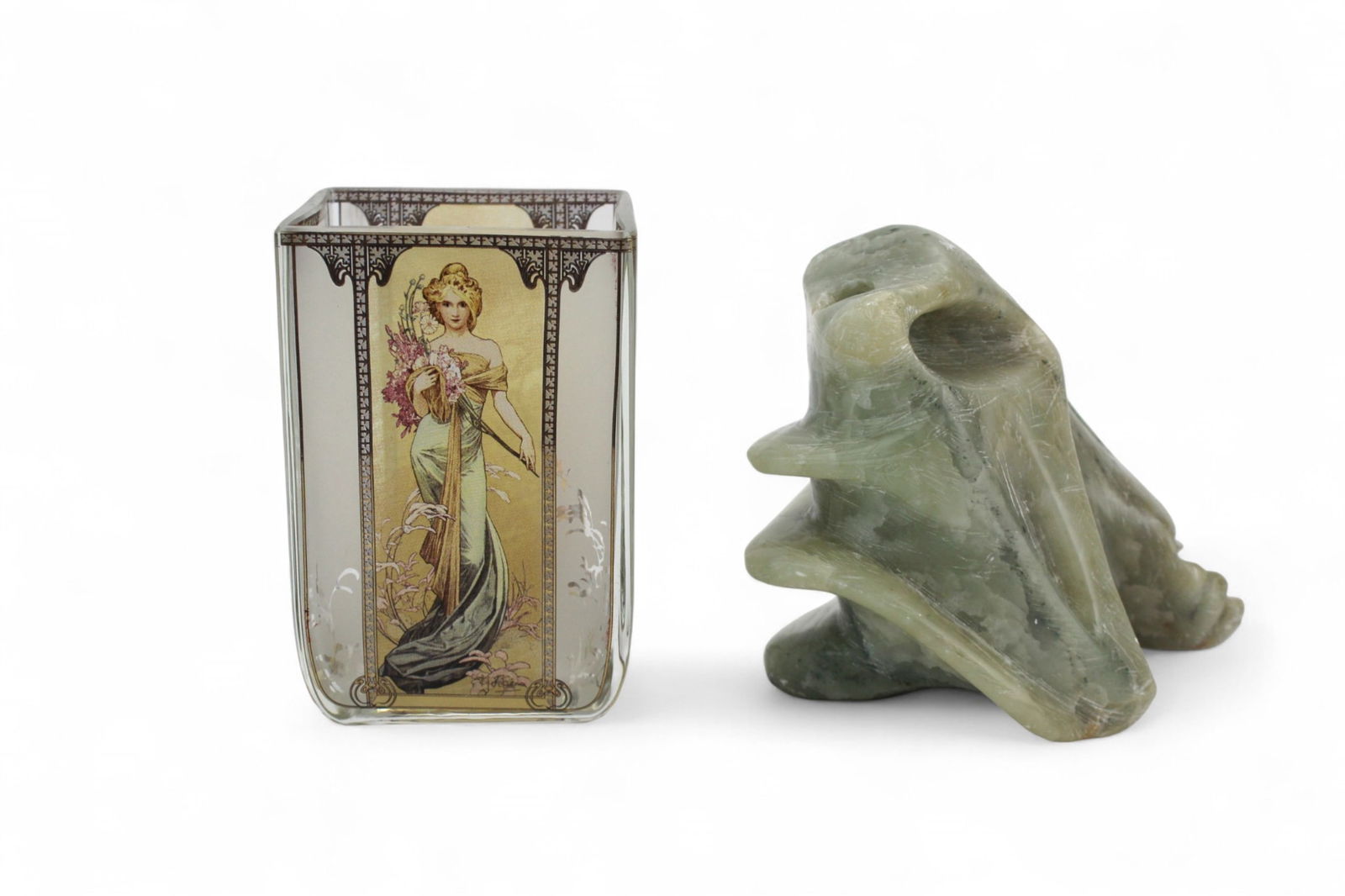 Goebel Mucha Glass Vase & Soapstone Carving: Goebel Mucha Spring 1900 glass vase and green soapstone carving, each 4 in. high. Both in good condition with light wear; soapstone shows natural inclusions and surface scratches.