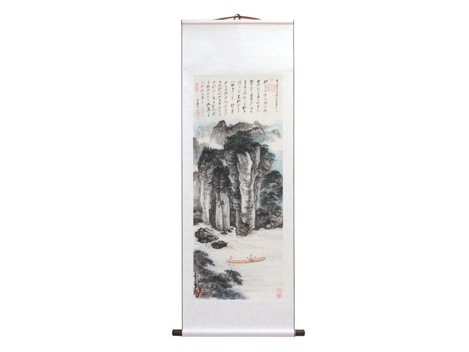 Chinese W/C Style Scroll with Mountains Scene: Chinese watercolor-style scroll painting depicting towering misty mountains, pine forests, and a small boat with scholars crossing a tranquil river. Includes poetic calligraphy and multiple red