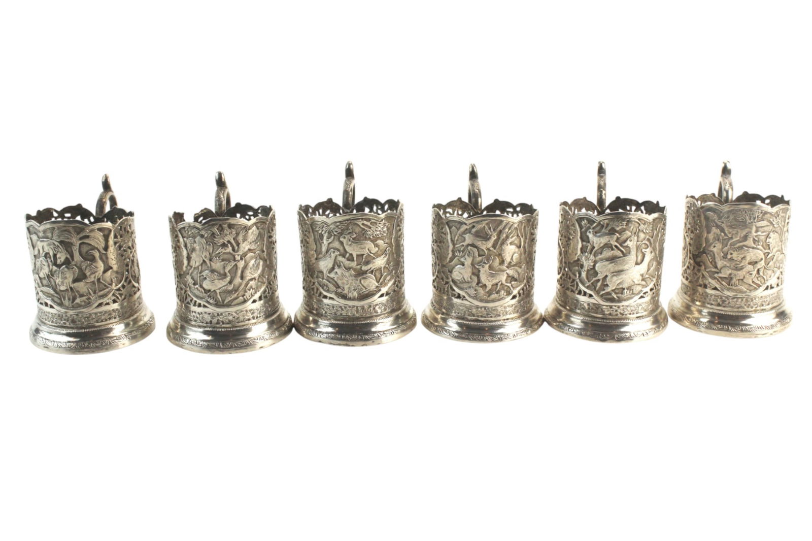 Set of Six Persian Sterling Silver Cup Holders: Set of six Persian sterling silver openwork cup holders decorated with animal and bird motifs. Each with scrolled handle and scalloped rim. Light tarnish and one with small rim losses. Approx. 2 1/4