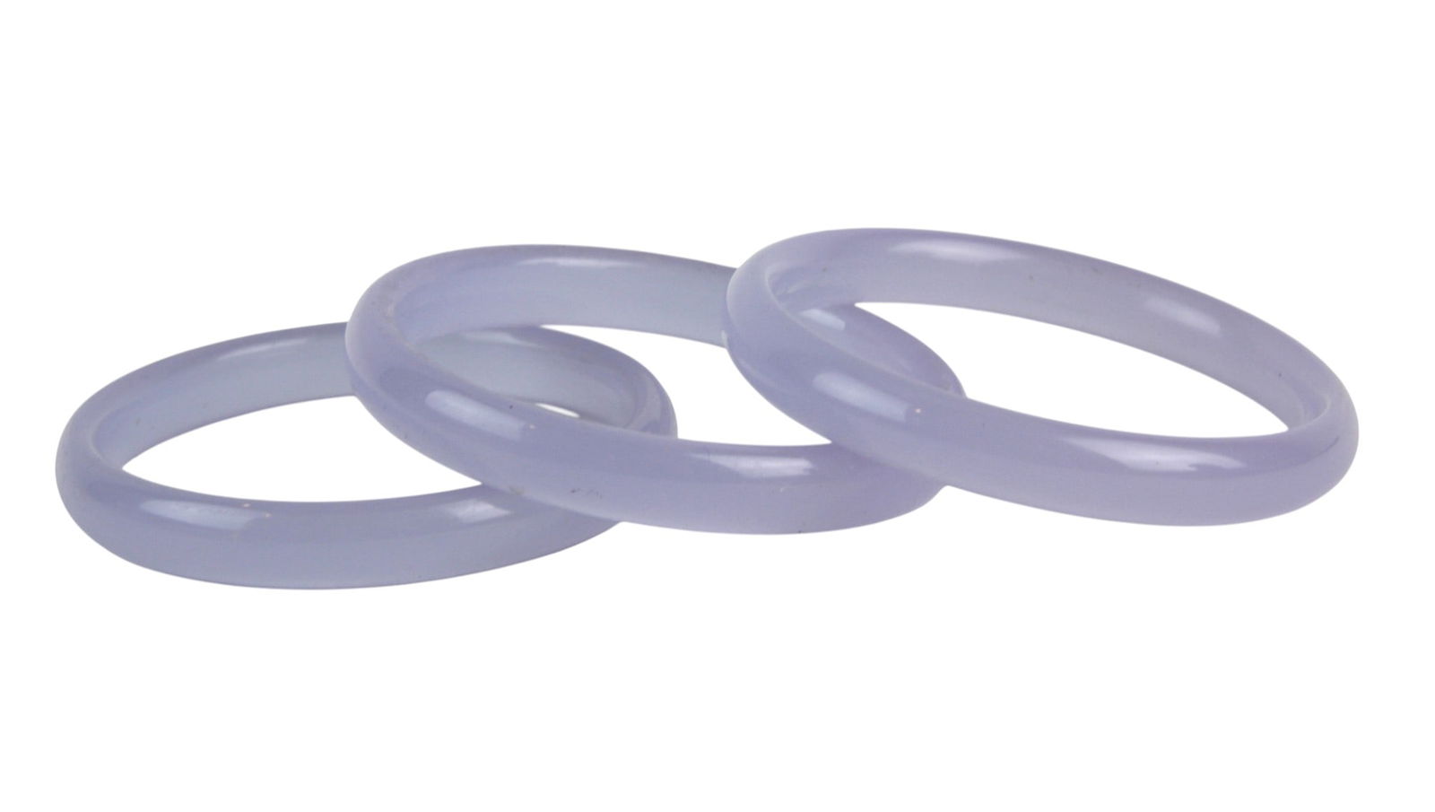 Three Lavender Hardstone Bangles Set: A set of three lavender hardstone bangles with a smooth, polished finish, measuring 67.5 mm outer and 55.4 mm inner diameter. In good condition with minor natural inclusions and light surface wear.