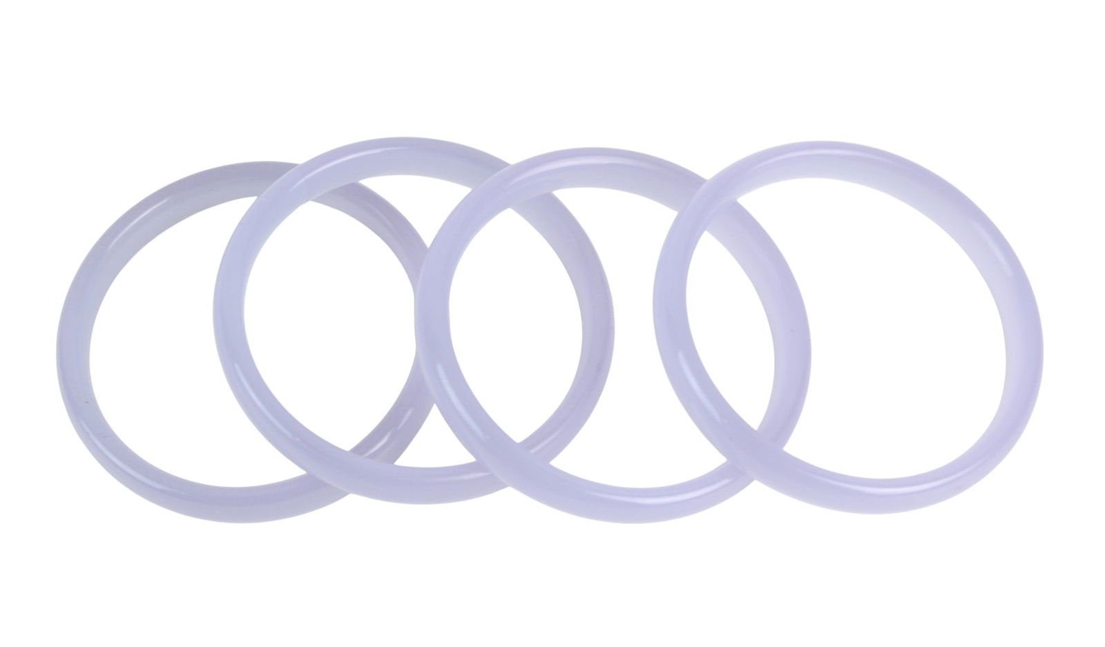 Four Lavender Hardstone Bangles: Set of four polished lavender hardstone bangles, approx. 67 mm outer X 56 mm inner diameter each, with minor natural inclusions and light wear, one with minor crack.