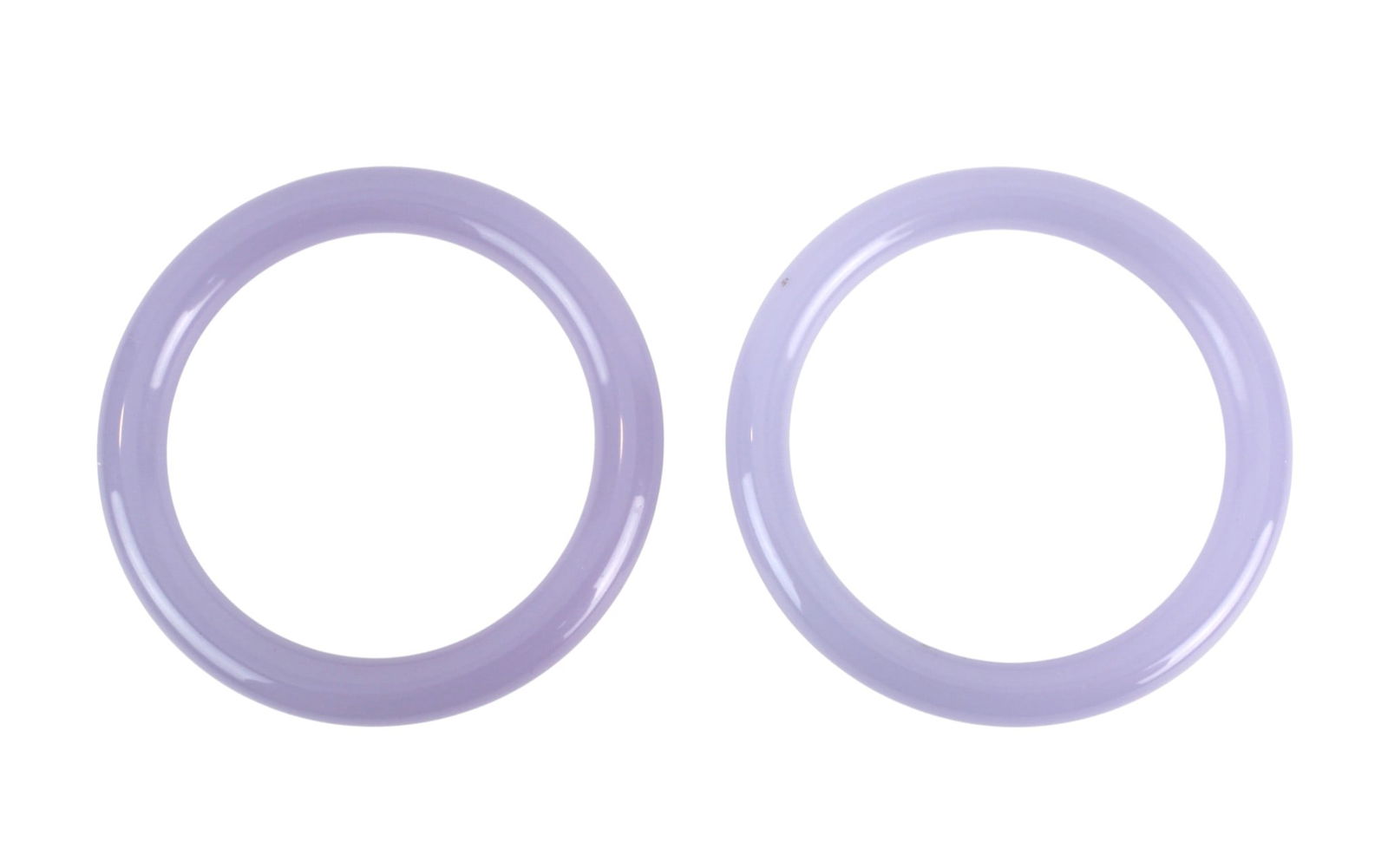 Two Lavender Hardstone Bangles: Pair of lavender hardstone bangles with smooth polish, measuring 72.2 mm (outer) X 54.4 mm (inner) diameter, in good condition with light surface wear and natural inclusions.