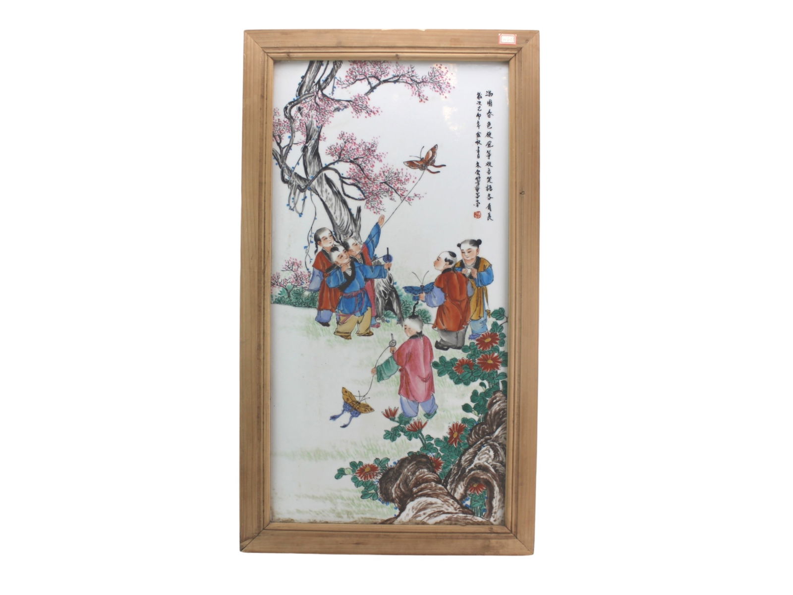 Chinese Porcelain Panel with Children Playing: A hand-painted Chinese porcelain panel showing children flying butterfly kites beneath a blooming tree, with calligraphy and red seal. Finely detailed and vibrant. Porcelain in excellent condition;