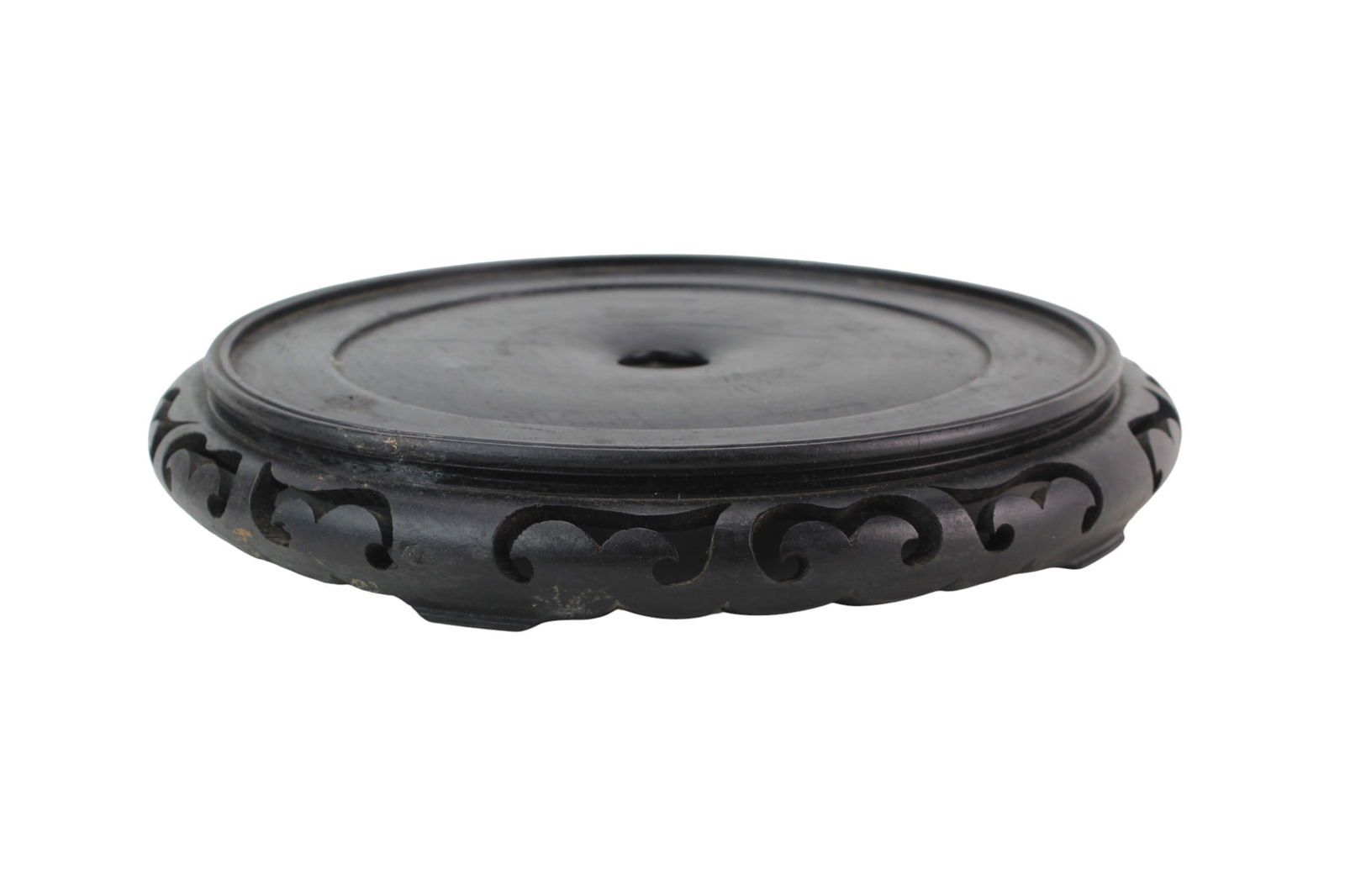 Large Carved Hardwood Display Stand: Carved hardwood stand with openwork scroll design and recessed top, showing minor wear and scratches. Size: 1 3/4 in. (H) X 12 in. (D).