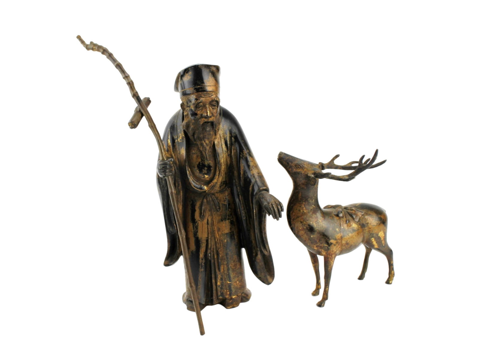 Asian Bronze Longevity Man and Deer Figures: A finely cast pair of Japanese bronze sculptures depicting the God of Longevity (Jurojin) and a deer, with traces of original gilt and lacquer. The elder figure measures approximately 10¾