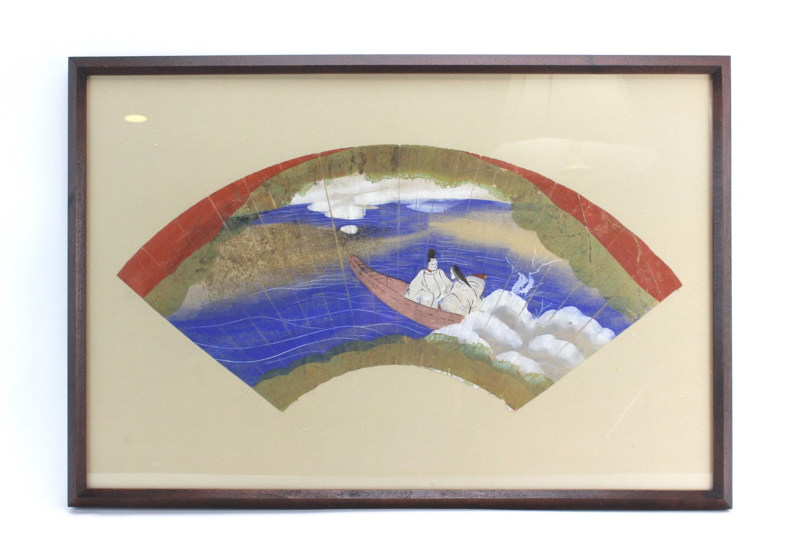 Framed Japanese Hand-Painted Fan Art – River Boat: Framed Japanese hand-painted fan art depicting two figures in a boat on a river, rendered in vivid colors with classical Heian-style detail. It measures Approx. 9 in. (H) X 19 in. (L).