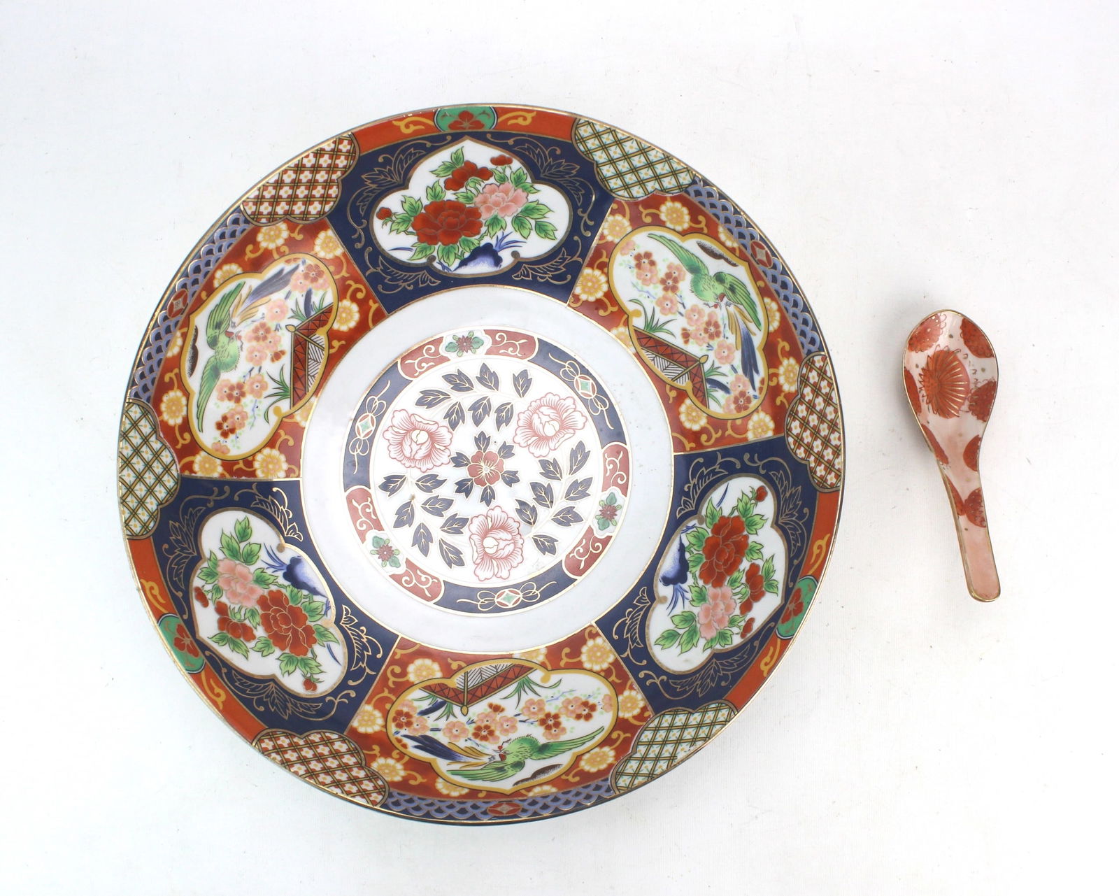 Japanese Imari Bowl and Porcelain Spoon: Japanese Imari bowl (11 3/4 in. Diam. X 3 in.H.) and 5 1/2 in. L. spoon, with bright enamel and gilt decoration, showing light wear, minor gilt rubbing, and small firing flaws.