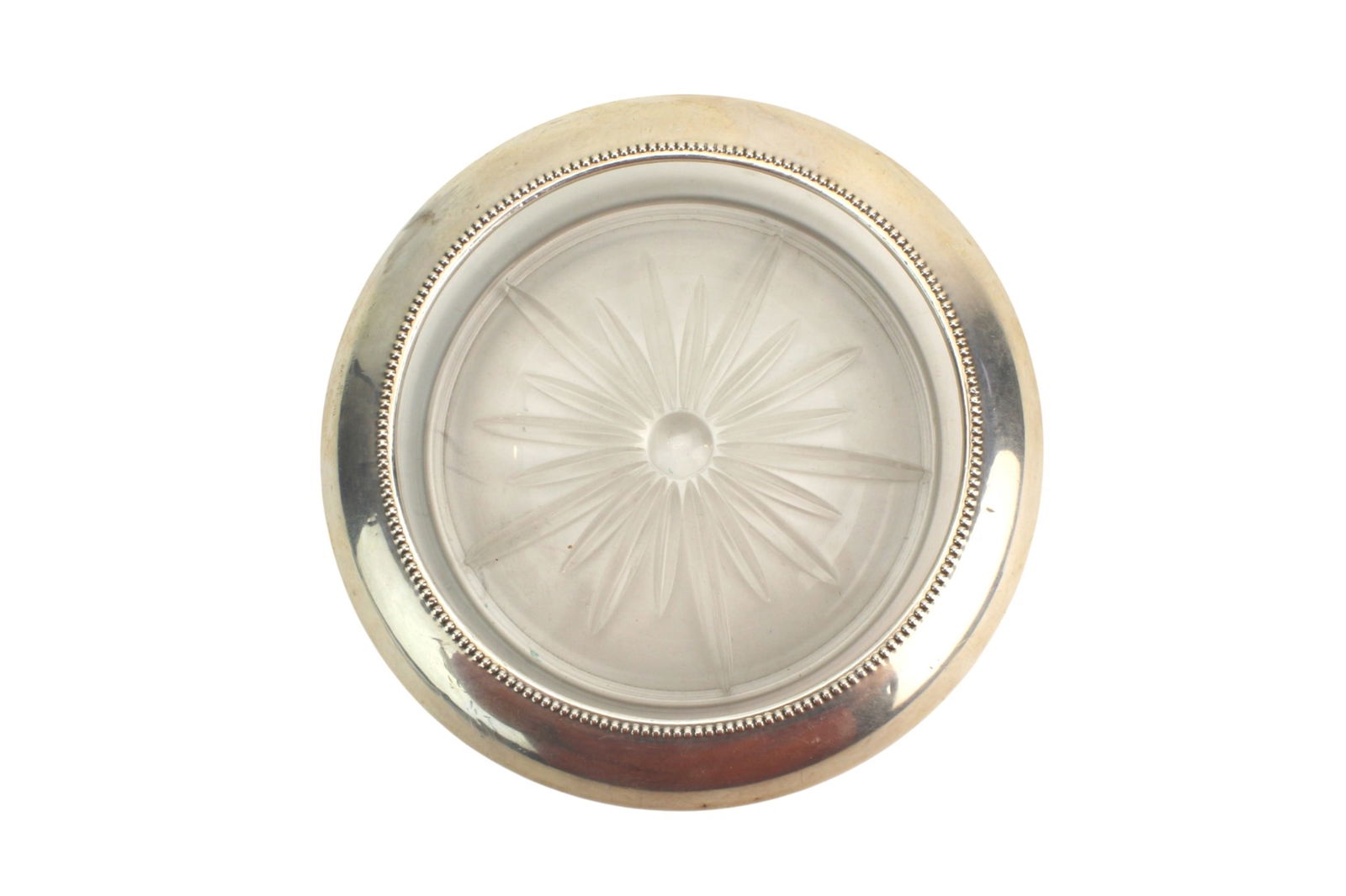 Frank Whiting Sterling Glass Coaster: Frank Whiting sterling-mounted glass coaster featuring a frosted starburst-cut glass center within a beaded sterling silver rim. Measures 7 in. (D). Marked Frank M. Whiting & Co., Sterling, Pat.