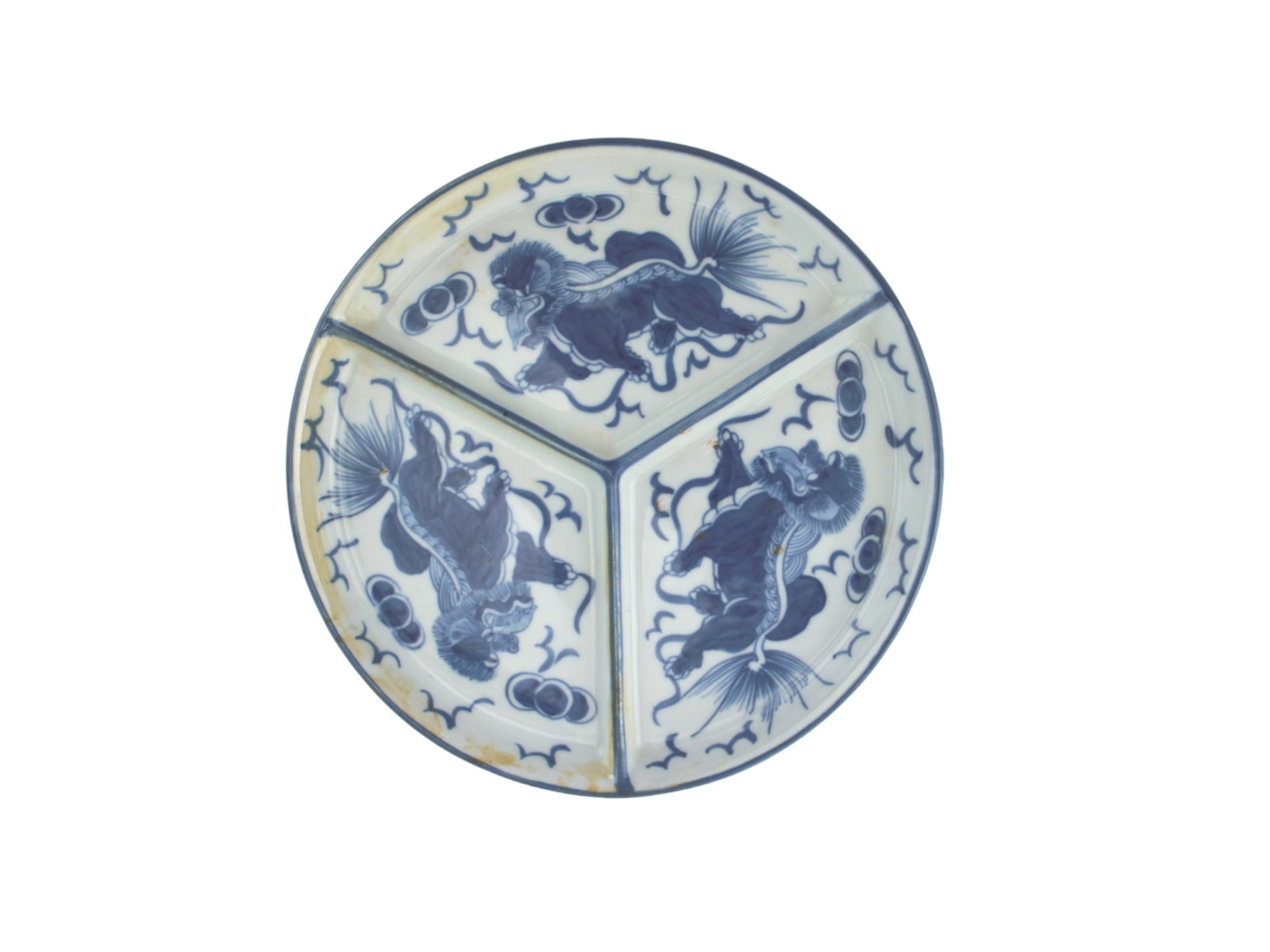 Chinese Blue & White Divided Dessert Dish: A Chinese blue and white porcelain plate, divided into three sections, each decorated with a Foo lion surrounded by cloud and ball motifs. The plate shows signs of age with discoloration and wear, and