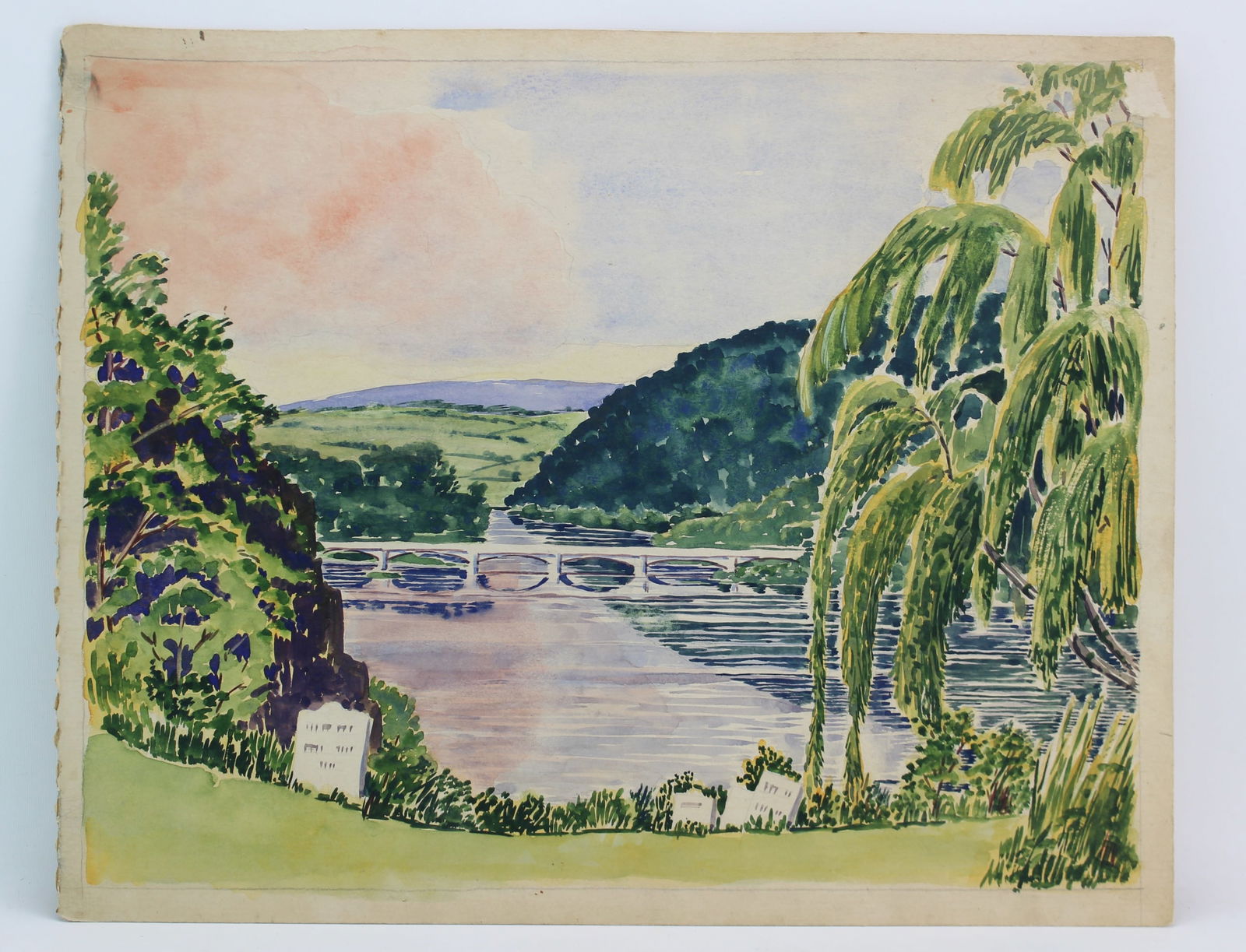 River Bridge Landscape Watercolor Scene: Original watercolor painting depicting a serene river landscape with a bridge, lush greenery, and a soft sunset sky. The painting, measuring 15 inches in height by 19 inches in width, is unsigned. It
