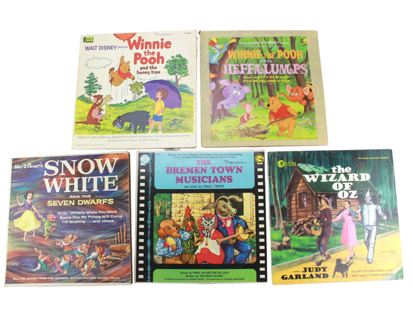 Five Children's 12-inch Vinyl Audio Records: Including: 1) Disneyland Record, Winnie the Pooh and the Honey Tree; 2) MGM Records, The Wizard of OZ; 3) Golden Record, The Bremen Town Musicians as told by Paul Tripp; 4) Disneyland Record, Snow Whi