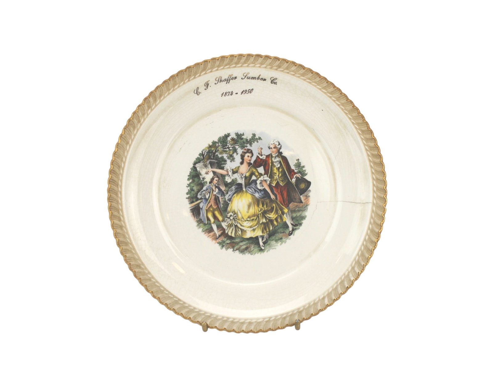 C. F. Shaffer Lumber Co. Anniversary Plate: Commemorative decorative plate by McArthur Pottery Co., marked for C.F. Shaffer Lumber Co. (1874–1950). Features a Rococo-style scene with gold trim, 22K gold stamp, and signs of age including crazi