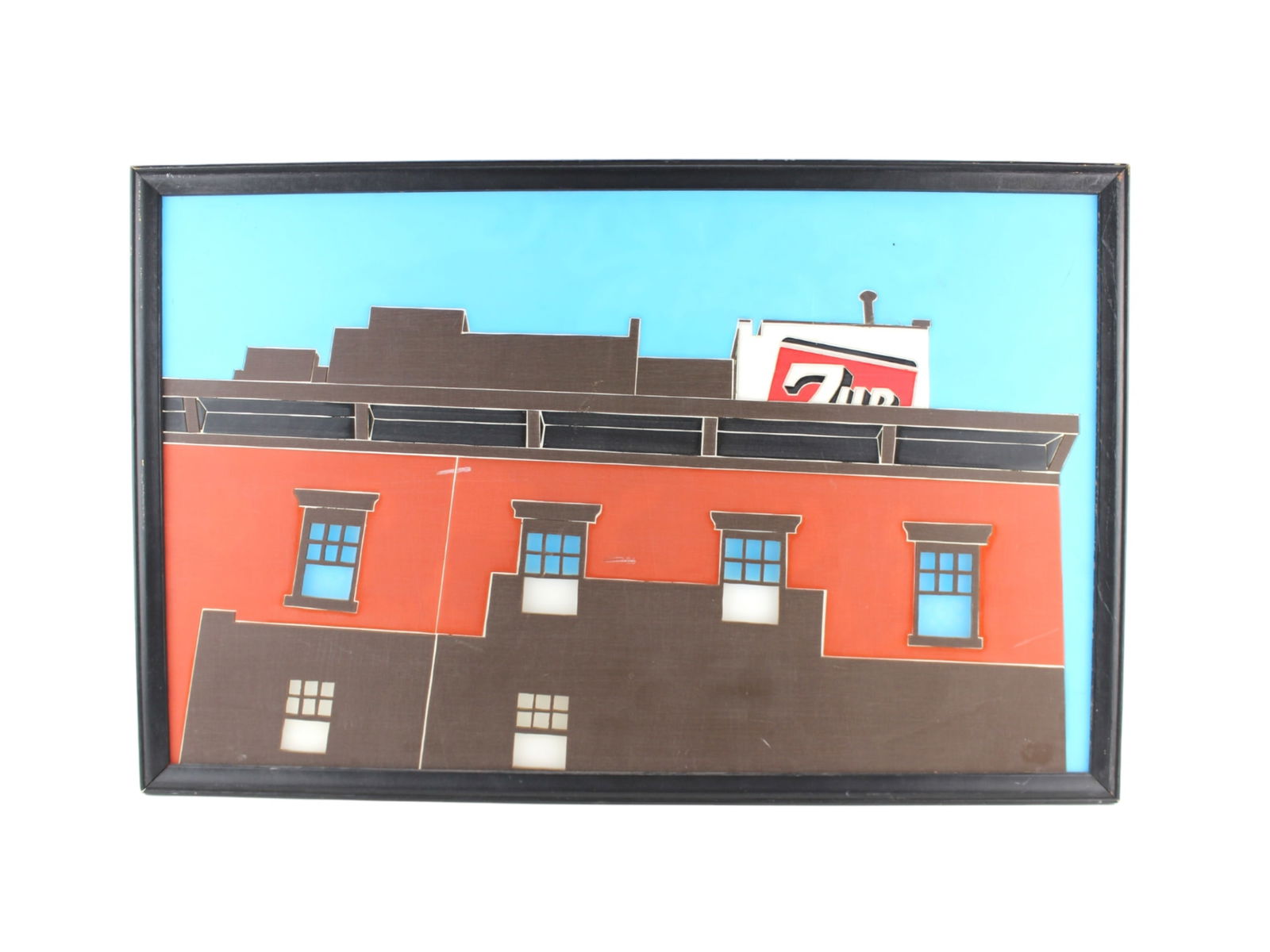 Framed Pop Art Wall Sculpture Featuring 7Up Sign: Framed three-dimensional wall art depicting a red-brick building with a vintage 7Up sign on the roof. Crafted with layered colored acrylic in a pop art style, it combines architectural detail with