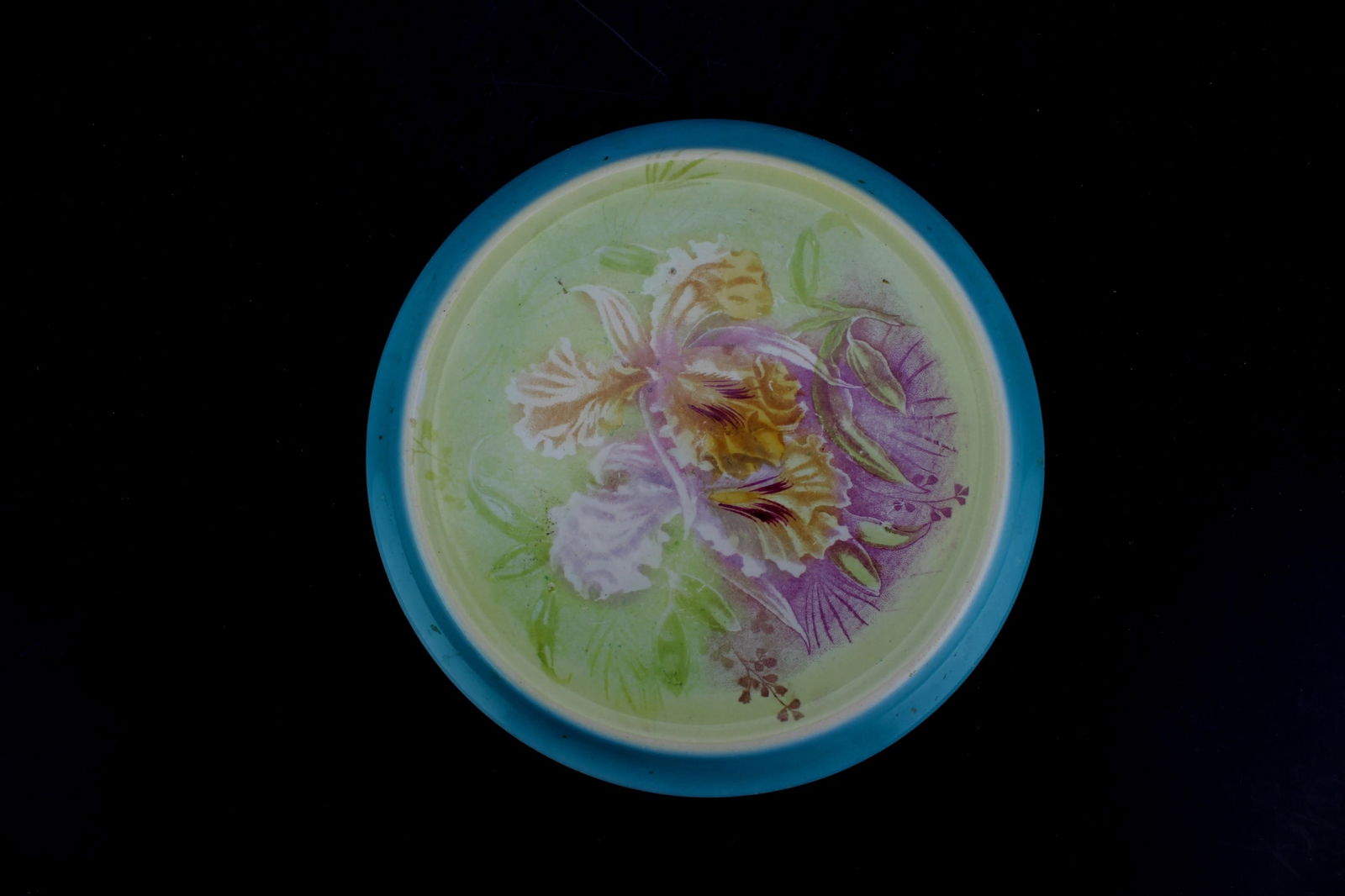 Franz Anton Mehlem Bonn Floral Majolica Trivet: Antique colorful majolica trivet by Franz Anton Mehlem of Bonn, Germany, featuring a raised orchid design with a turquoise rim and marked on the base. 19th to early 20th-century. Dimension: 7 inches