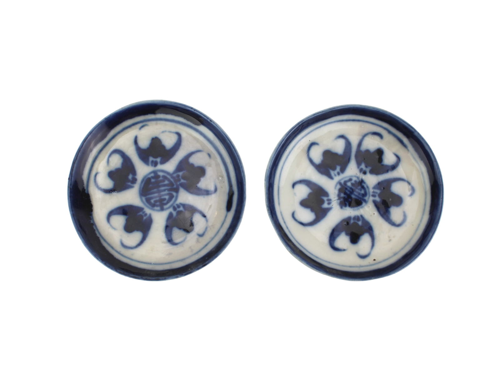 Two Chinese Blue & White Porcelain Saucers: A pair of shallow porcelain dishes decorated in underglaze blue, each featuring five bats surrounding a central Shou (longevity) symbol. The bats are arranged in a circular motif. The dishes show