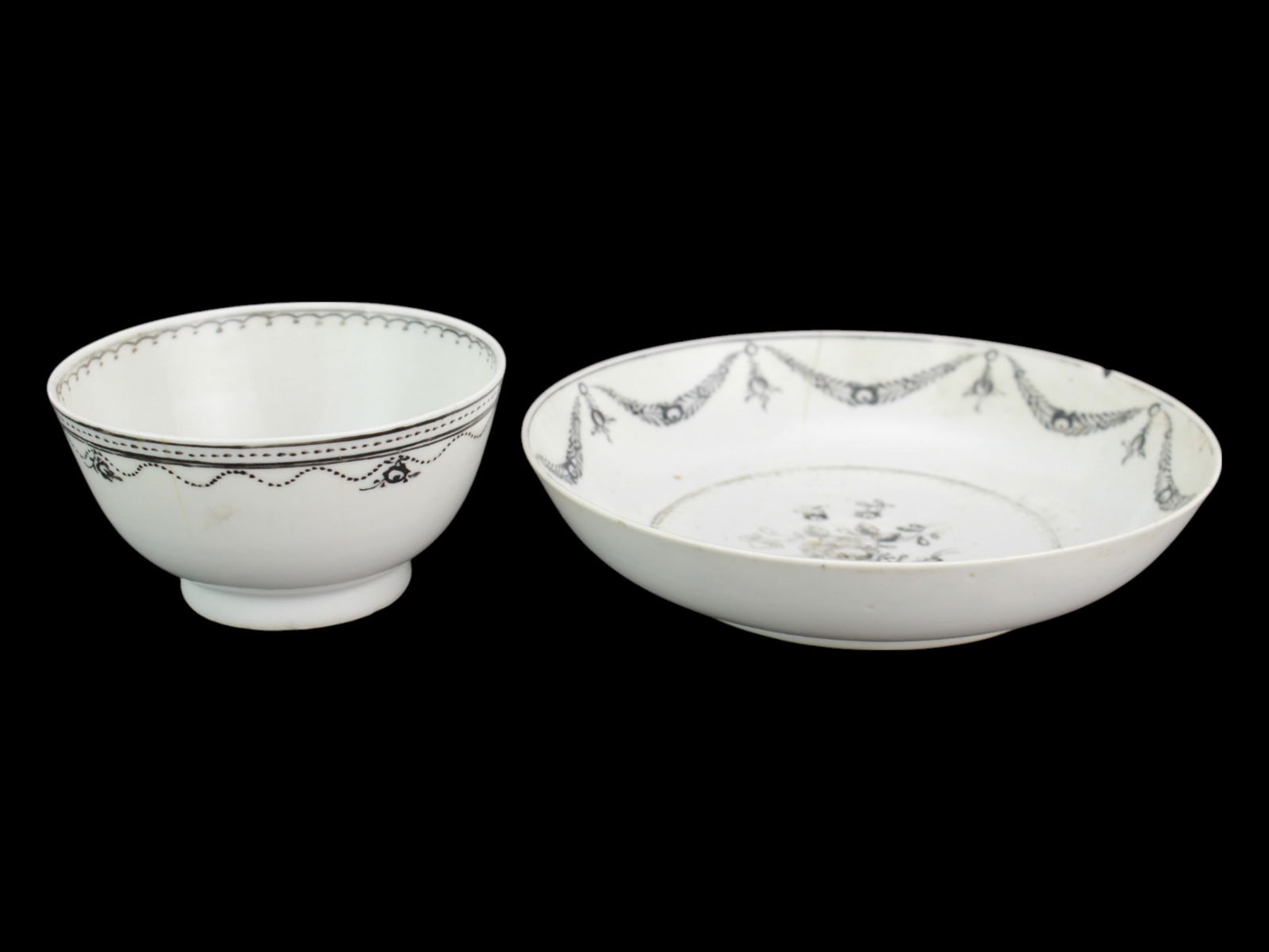 Chinese Export Famille Rose Teacup and Saucer: An 18th-century Chinese export porcelain teacup and saucer set, decorated in fine grisaille (black enamel) with floral motifs and garland swags. Some age-related wear and minor rim chips are present.