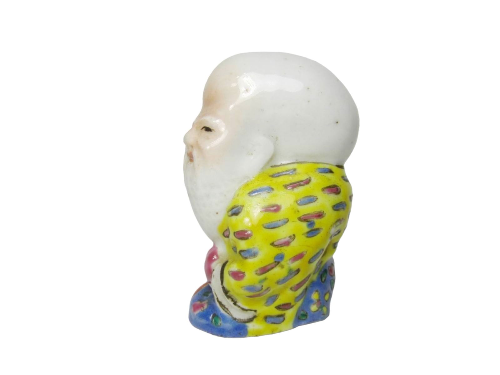 Chinese Famille Rose Shoulao Porcelain Figure: Chinese famille rose porcelain figure of Shoulao, God of Longevity, holding a peach and staff, decorated in vivid yellow, blue, and red enamels. Visible crack to back of head, minor glaze flaws, and a