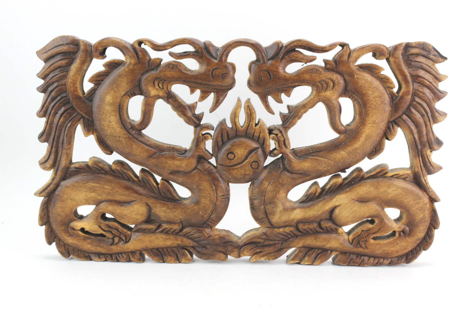 Carved Wood Dragon Wall Panel: Openwork carved wood wall hanging depicting two confronting dragons surrounding a flaming pearl. Fitted with two metal hangers on the reverse for easy wall display. Measures approximately 18 in. (L) ?