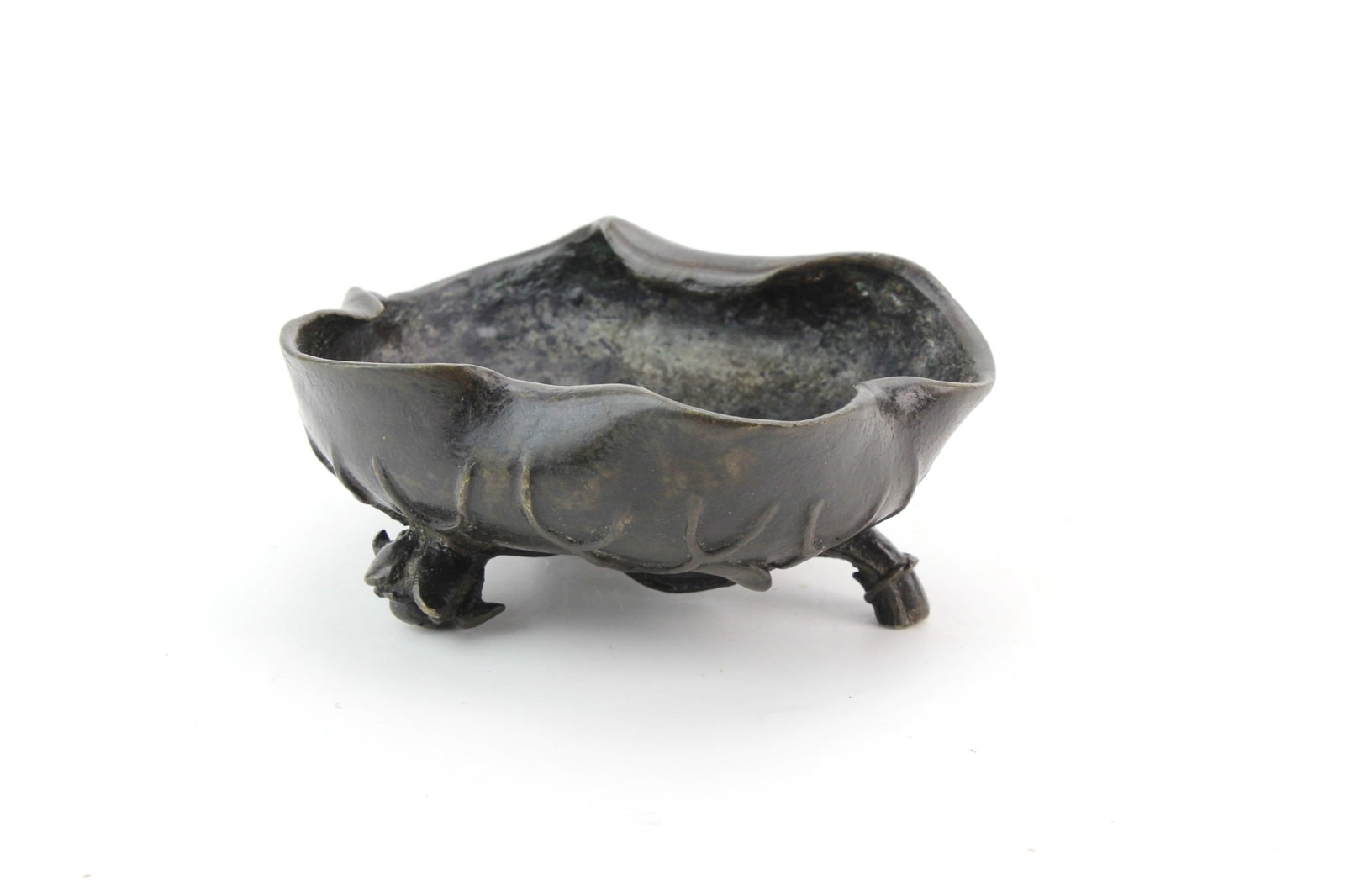 Antique Asian Bronze Lotus Leaf Bowl: Decorative bronze bowl modeled as a lotus leaf with naturalistic veining, vine, and lotus blossom details, raised on three stylized feet. Measures approximately 2 in. (H) ? 4 1/4 in. (L) ? 3 1/2 in.