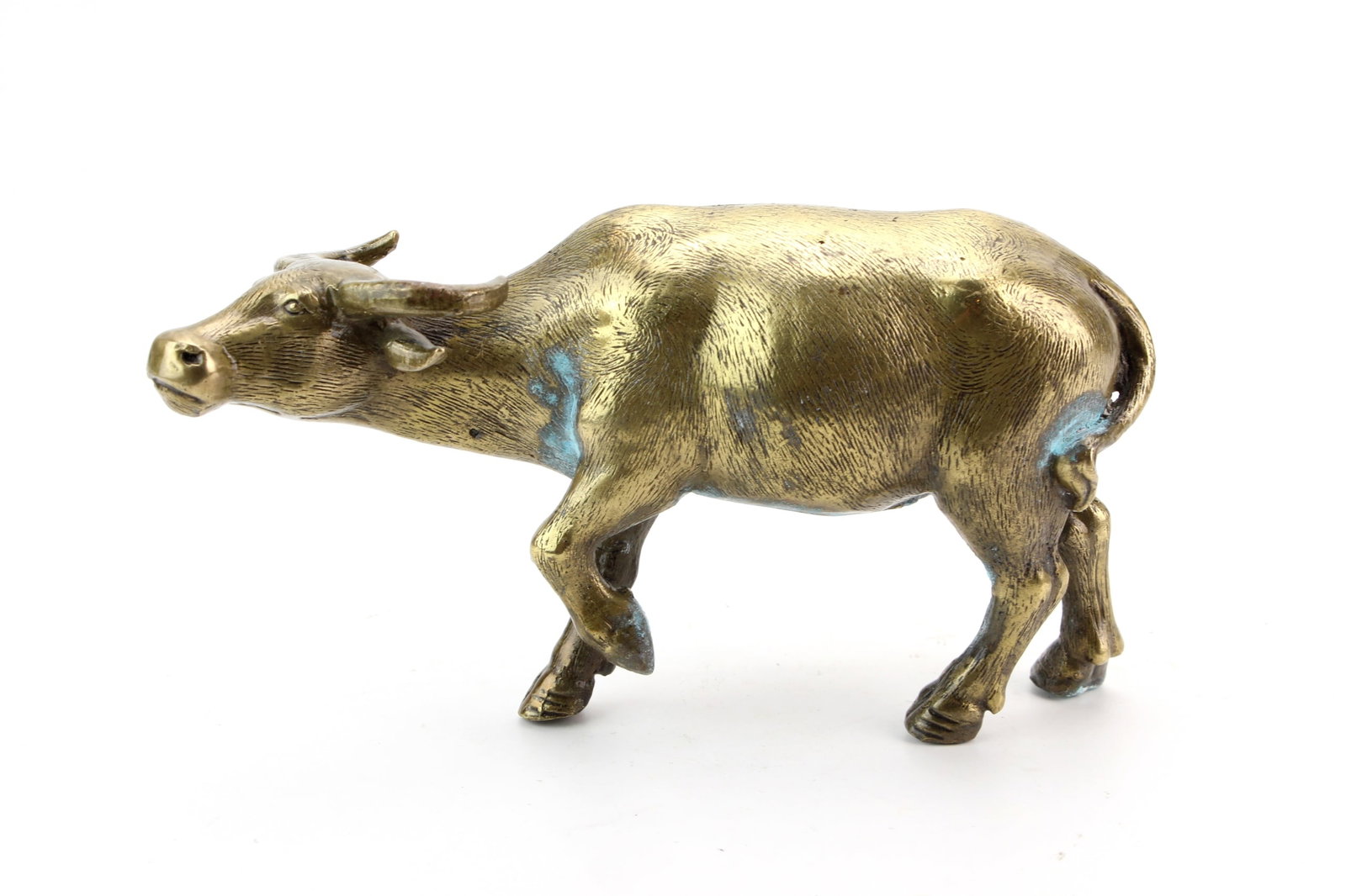 Bronze Water Buffalo Figurine: Cast bronze water buffalo figurine depicted in a walking stance with finely incised hair texture and naturalistic modeling. Measures approximately 4 1/4 in. (H) ? 7 1/2 in. (L) ? 2 1/2 in. (W).