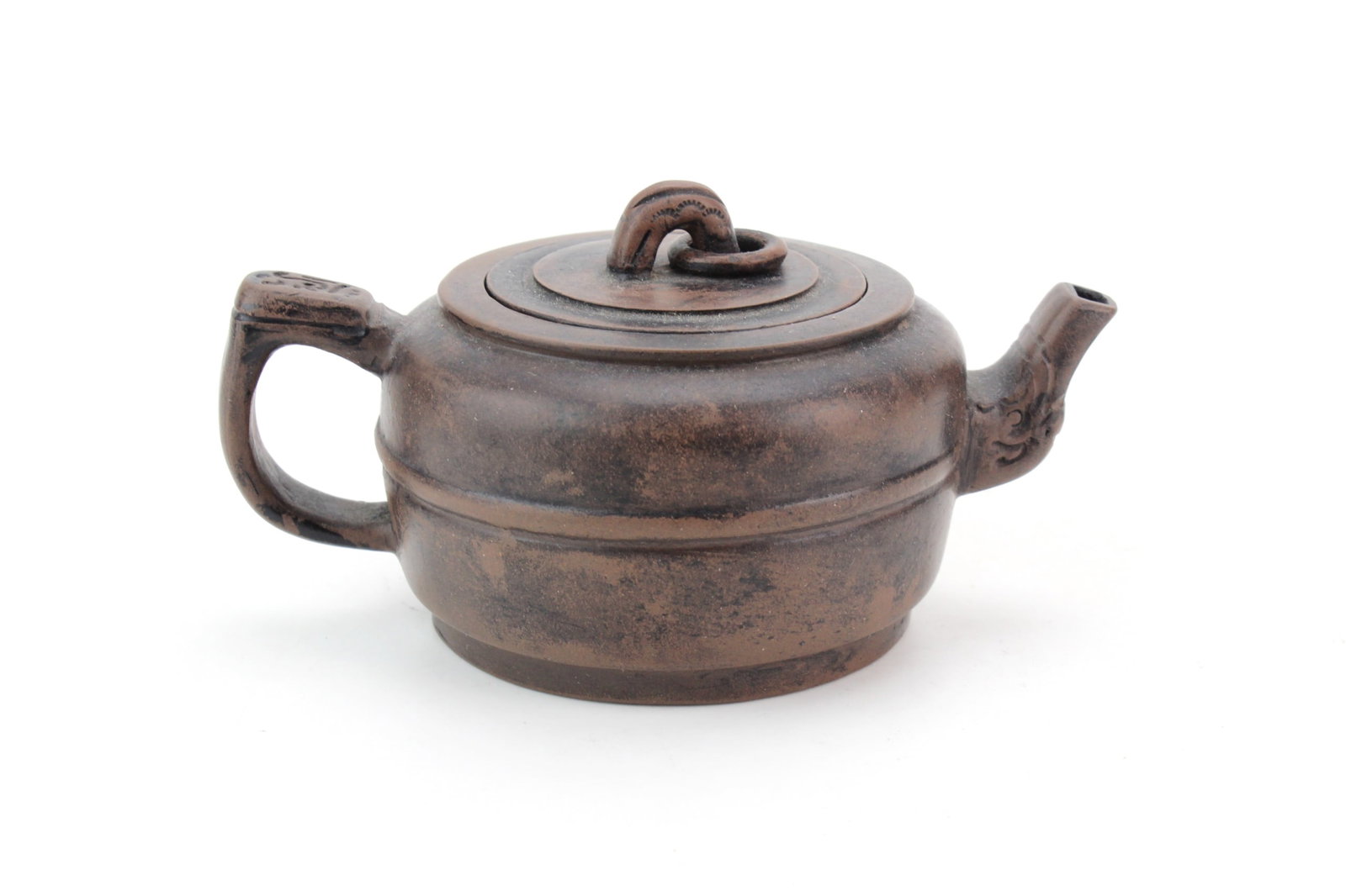 Yixing Zisha Clay Teapot: Yixing zisha clay teapot featuring a cylindrical body with a bamboo-form spout and handle, fitted lid, and impressed maker's marks on the base and underside of the lid. Measures approximately 2 1/2 in