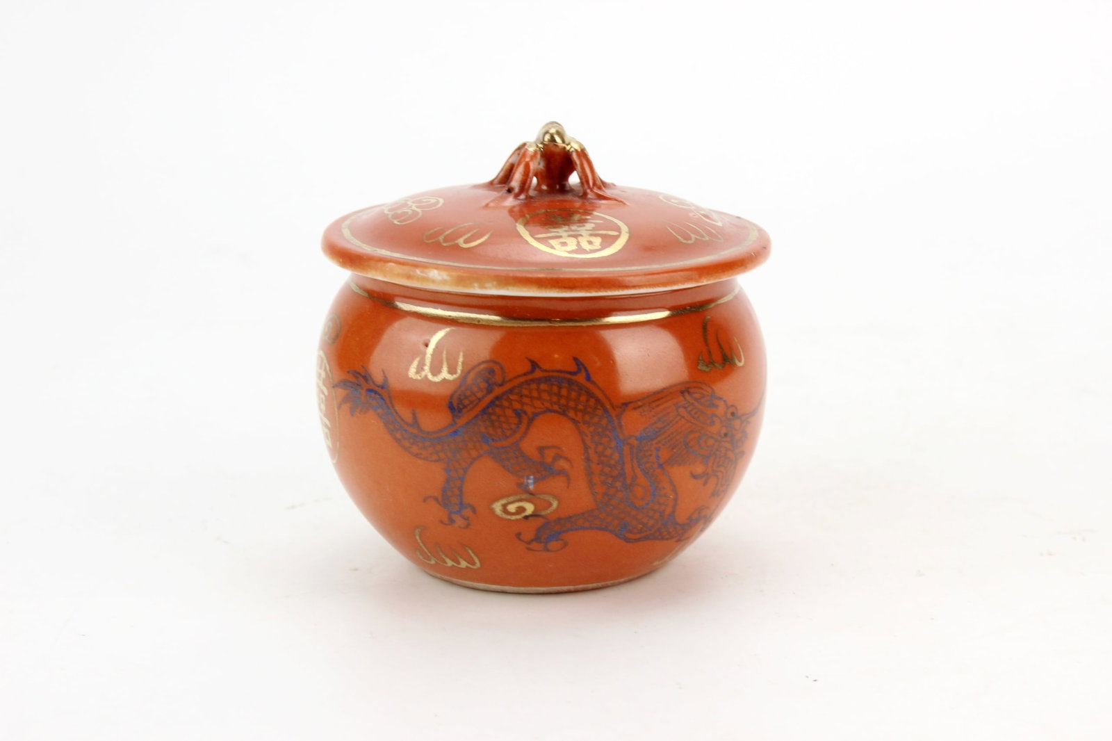 Chinese Porcelain Lidded Tea Jar: Chinese porcelain tea jar with cover, decorated in an iron-red glaze with blue dragons, gilt cloud motifs, and auspicious characters. The finial is accented with gilt details, and the base is marked