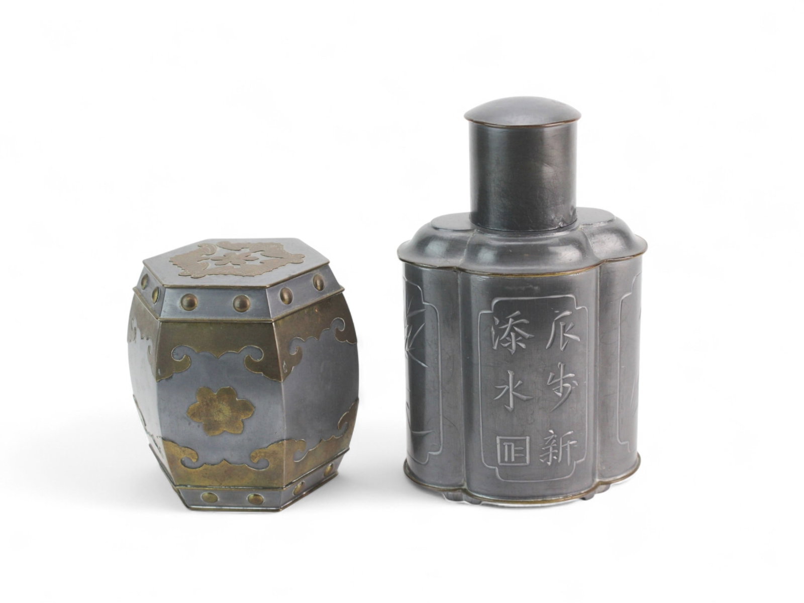 Two Vintage Hong Kong Tin Tea Canisters: Pair of vintage tin tea canisters marked ?Made in Hong Kong,? including a 6 1/2 in. floral-engraved lobed canister and a 4 in. hexagonal canister with brass-tone accents. Both in good vintage