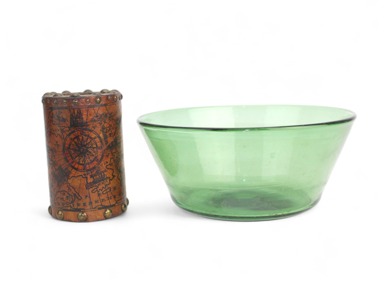 Green Glass Bowl & Antique Leather Brush Pot: Green glass bowl with bubbles and a leather brush pot with map and ship motif marked 1574, both in good condition with minor wear. Bowl 8 1/2 in. (D) X 3 1/2 in. (H); pot 4 1/2 in. (H) X 3 in. (D).