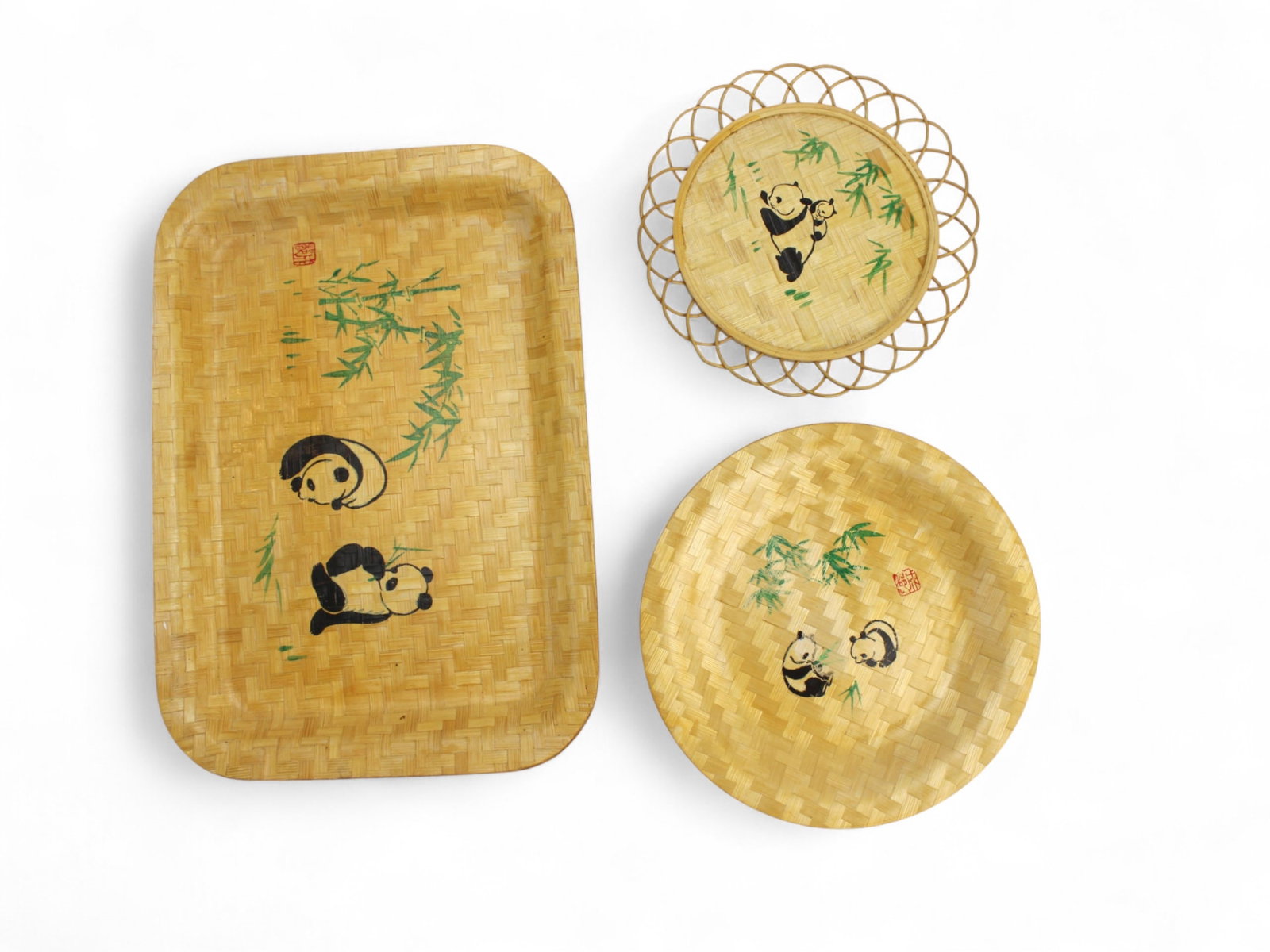 Group of Chinese Bamboo Panda Plates: Set of three hand-painted bamboo kitchen items featuring playful panda and bamboo designs, including one rectangular tray and two round plates. Light wear from age and use. Tray measures 13 x 9 in.;